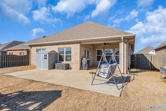 back of house featuring a storage shed, a patio area, and ceiling fan