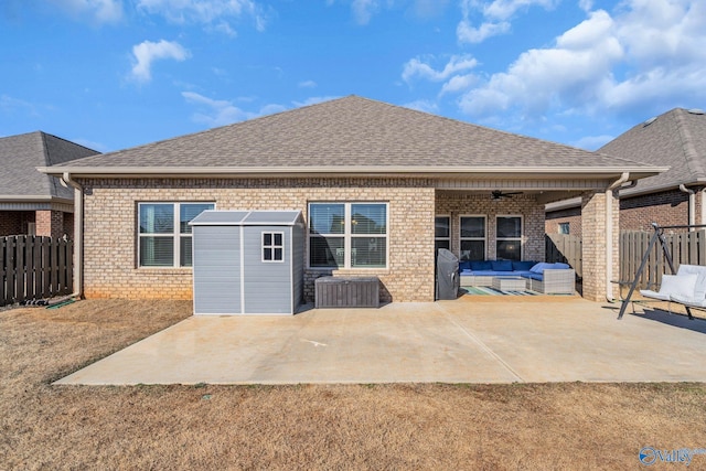 back of property featuring a patio area, a yard, ceiling fan, an outdoor hangout area, and a shed