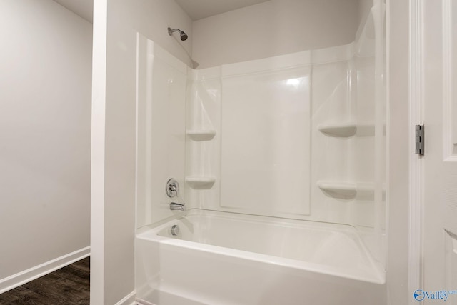 4025 Sherri St SW, Decatur, AL 35603 - bathroom featuring shower / washtub combination and wood finished floors