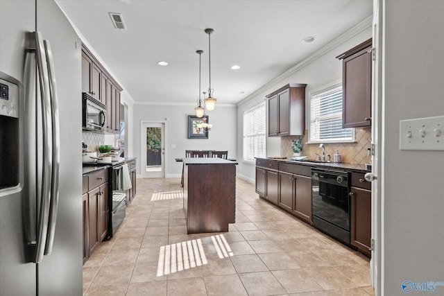 kitchen featuring hanging light fixtures, a kitchen island, black appliances, light tile patterned flooring, and decorative backsplash