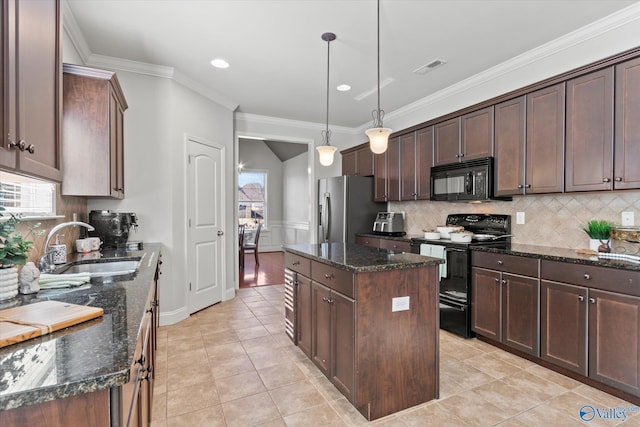 kitchen with pendant lighting, sink, black appliances, a kitchen island, and dark stone counters