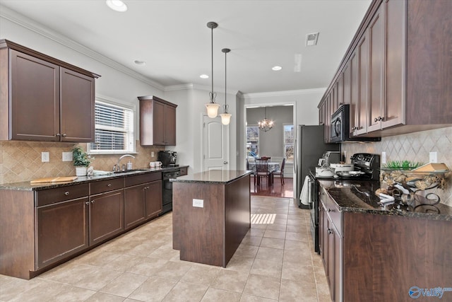 kitchen with pendant lighting, dark stone countertops, dark brown cabinets, a center island, and black appliances