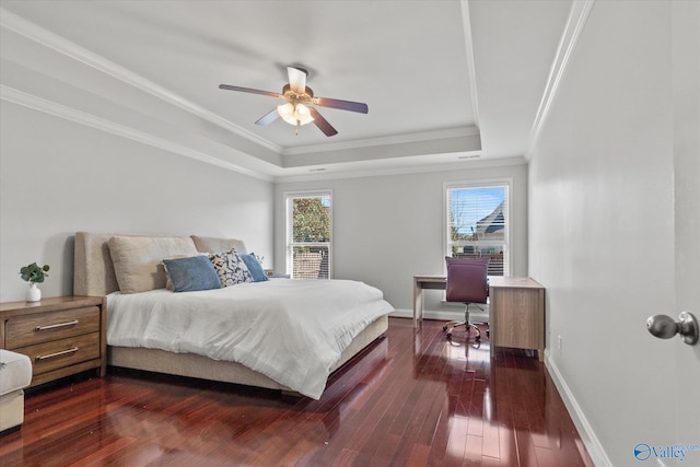 bedroom with ceiling fan, ornamental molding, a tray ceiling, and dark hardwood / wood-style flooring