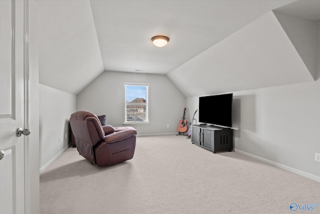 living area featuring vaulted ceiling and light carpet