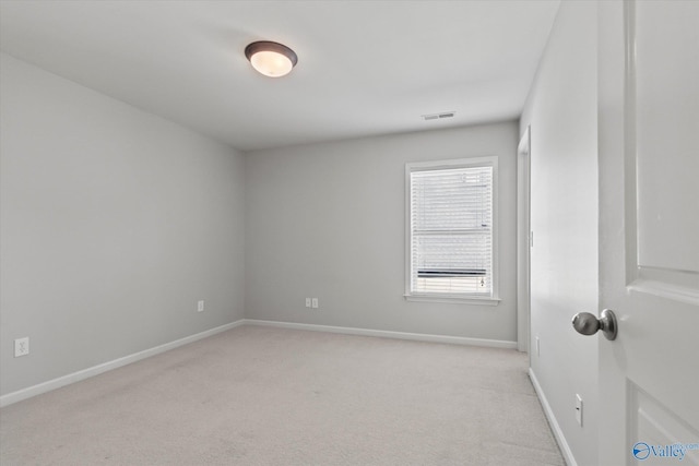 unfurnished room with light colored carpet