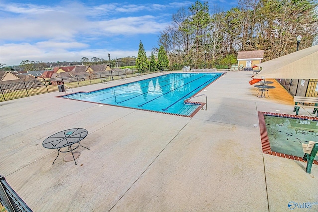 view of swimming pool with a patio area