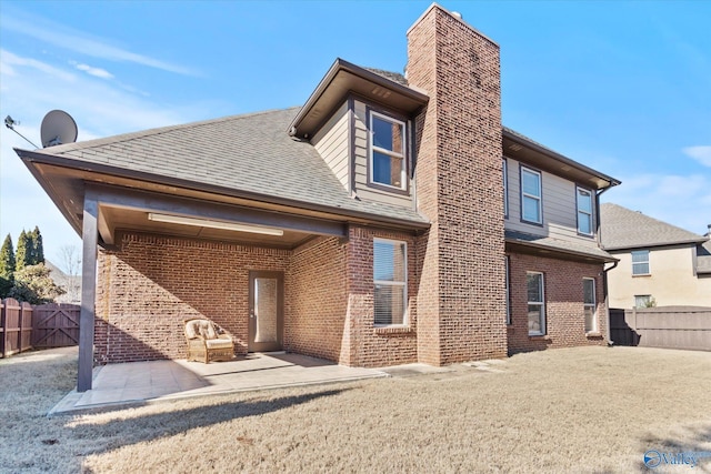 back of property with a patio and a lawn