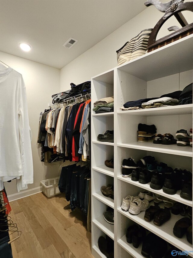 spacious closet featuring light hardwood / wood-style floors