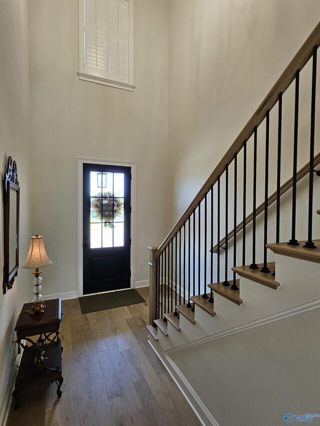 living room with crown molding, light wood-type flooring, a chandelier, and a brick fireplace