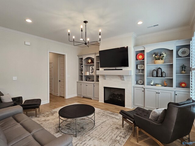 living room with sink, ornamental molding, a chandelier, and light hardwood / wood-style flooring