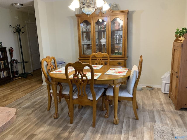 dining space featuring a chandelier and wood-type flooring