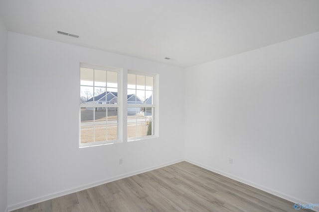 unfurnished room with light hardwood / wood-style floors