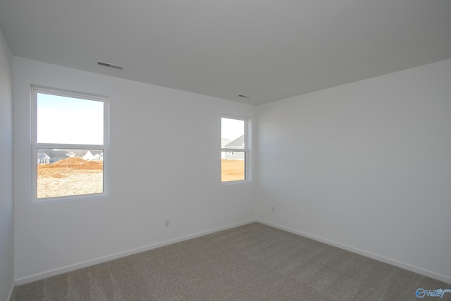 unfurnished room featuring carpet