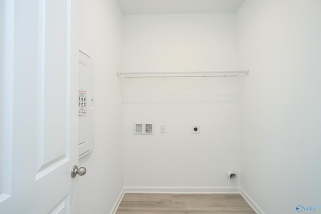 laundry room with light wood-type flooring, hookup for an electric dryer, and hookup for a washing machine