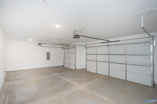 garage with a garage door opener and electric panel