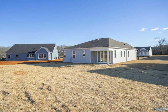 rear view of house with a lawn