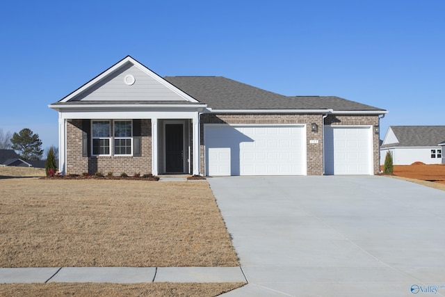 view of front of property featuring a garage and a front yard