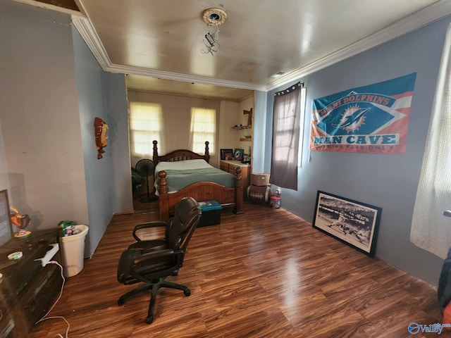 bedroom featuring ornamental molding and wood finished floors