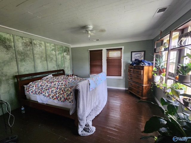 bedroom with visible vents, ceiling fan, and hardwood / wood-style flooring