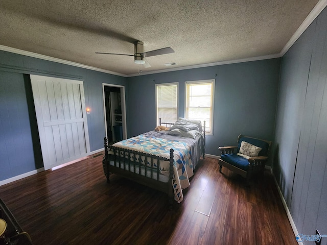bedroom with a ceiling fan, baseboards, ornamental molding, and wood finished floors