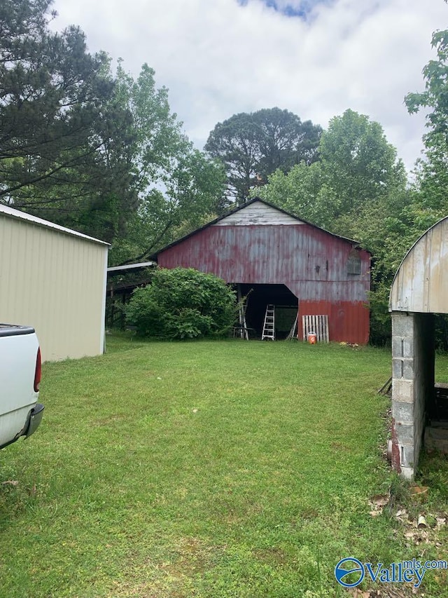 view of yard featuring an outbuilding and a pole building