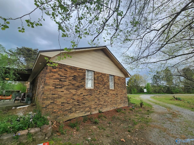 view of side of property featuring brick siding