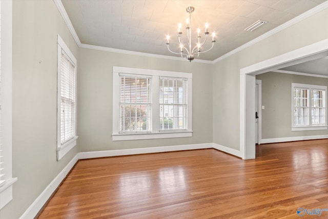 unfurnished dining area featuring ornamental molding, a notable chandelier, and hardwood / wood-style flooring