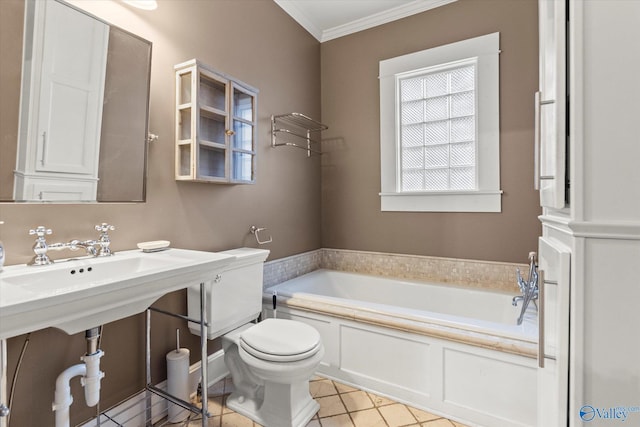 bathroom with crown molding, a washtub, and toilet