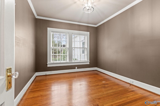 empty room with wood-type flooring and ornamental molding