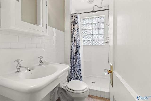 bathroom with toilet, sink, tile patterned flooring, and a shower with shower curtain