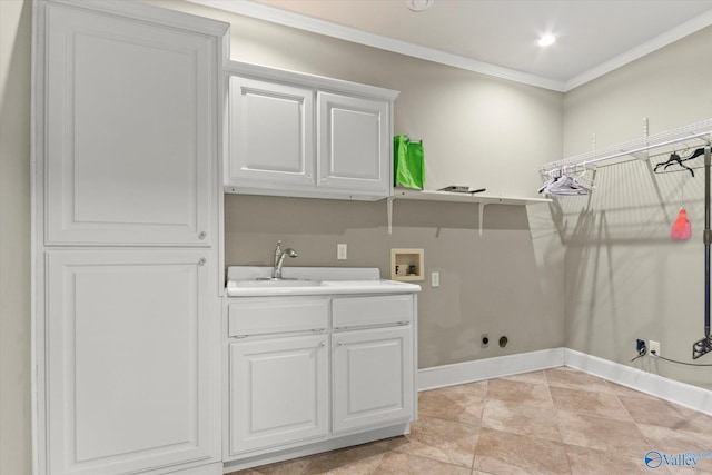 laundry area featuring crown molding, sink, cabinets, and washer hookup