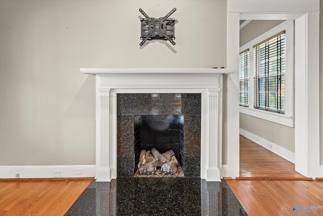 interior details featuring hardwood / wood-style flooring and a fireplace