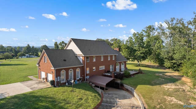 view of front of home featuring a garage, driveway, a front yard, and brick siding