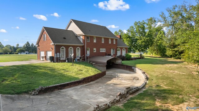 colonial house with a garage and a front lawn