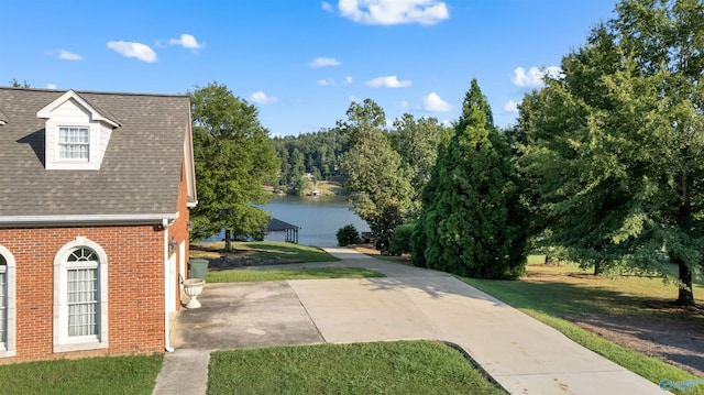 exterior space with a yard and a water view