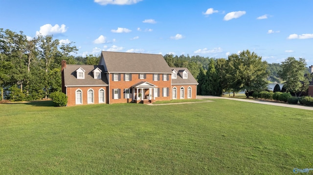 view of front of home with brick siding and a front yard