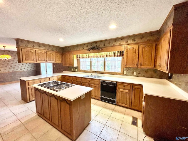 kitchen with stainless steel electric cooktop, black dishwasher, sink, and a textured ceiling