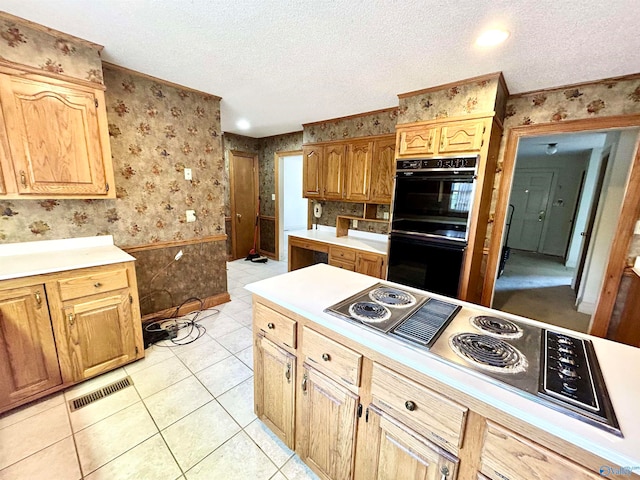 kitchen featuring black double oven, electric stovetop, light tile patterned floors, and a textured ceiling