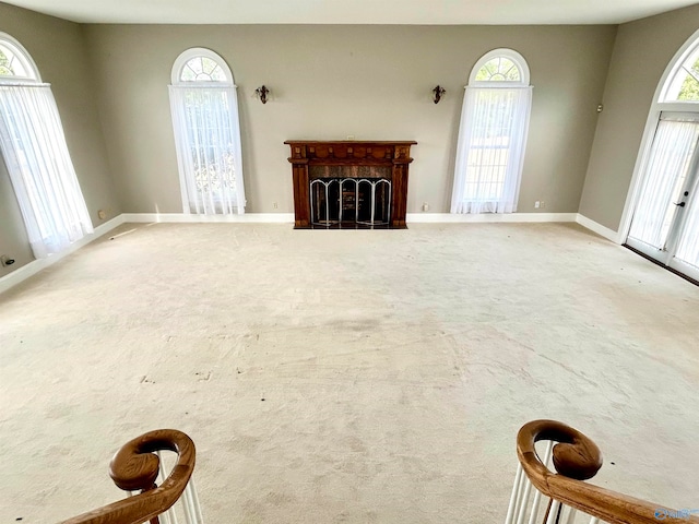 unfurnished living room with plenty of natural light and carpet floors