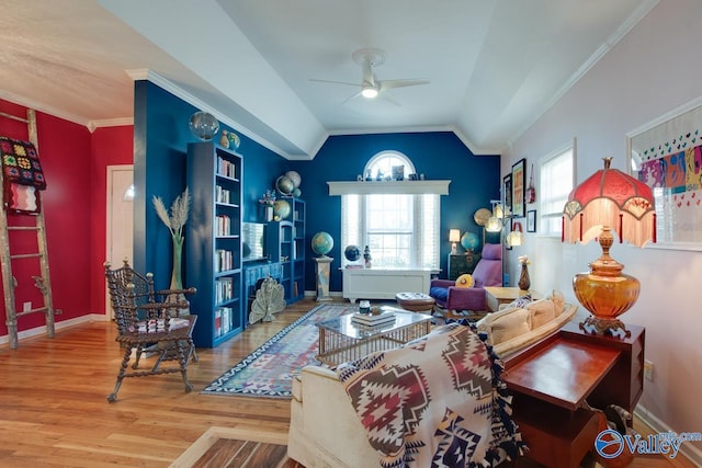 living room with wood-type flooring, ornamental molding, ceiling fan, and lofted ceiling