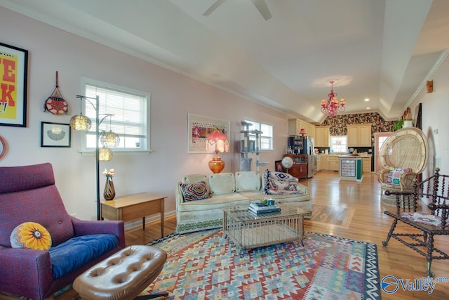 living room with crown molding, ceiling fan, and light hardwood / wood-style floors