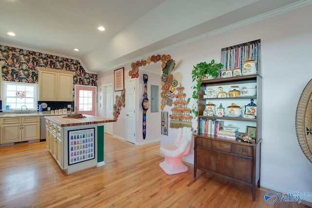 kitchen featuring dishwasher, a center island, cream cabinetry, and wood counters