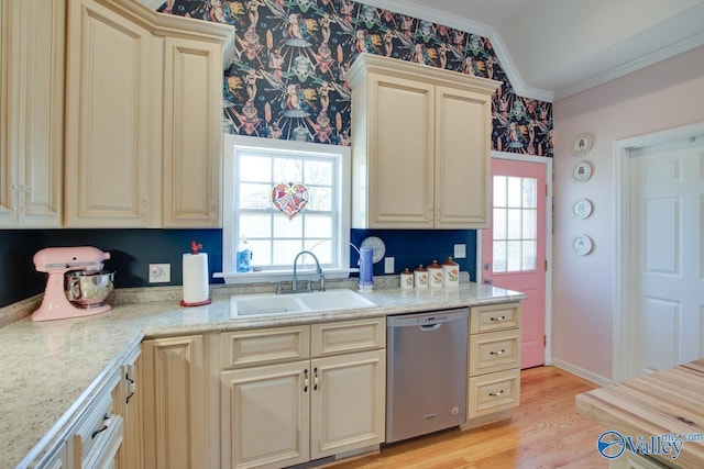 kitchen with stainless steel dishwasher, ornamental molding, sink, and cream cabinetry