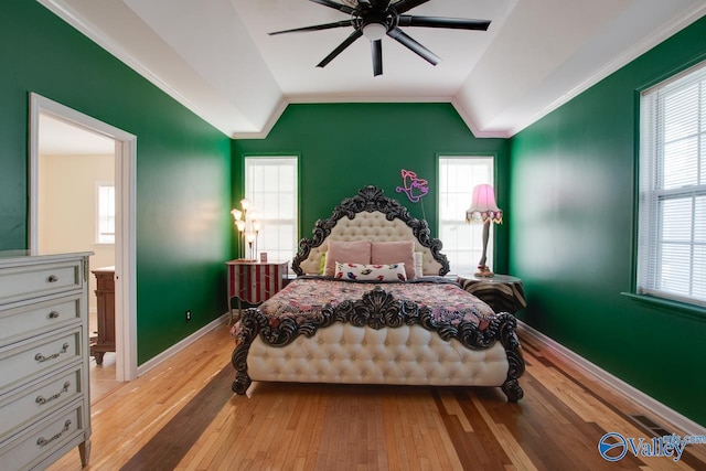 bedroom featuring light hardwood / wood-style flooring, crown molding, ceiling fan, and lofted ceiling