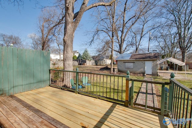 wooden terrace with a yard, a carport, and an outdoor structure