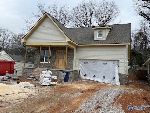 view of front of home featuring a garage and a porch