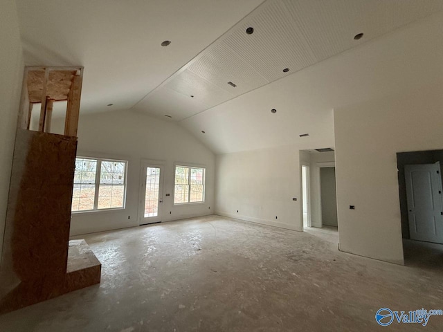 unfurnished living room featuring high vaulted ceiling