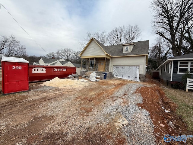 view of front of property featuring a garage and covered porch