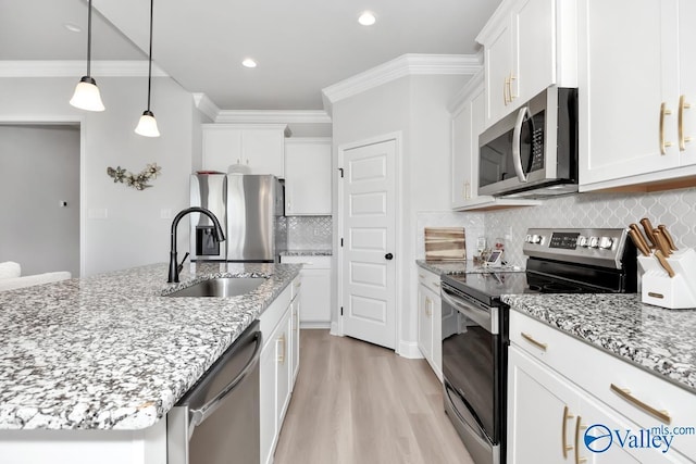 kitchen with decorative backsplash, white cabinetry, sink, and appliances with stainless steel finishes