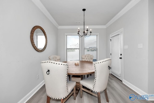 dining area featuring hardwood / wood-style floors, a notable chandelier, and crown molding